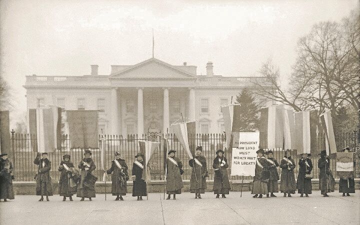 National Woman’s Party demonstration in the front of the White House in 1918. The banner protests President Wilson’s failure to support women’s suffrage.